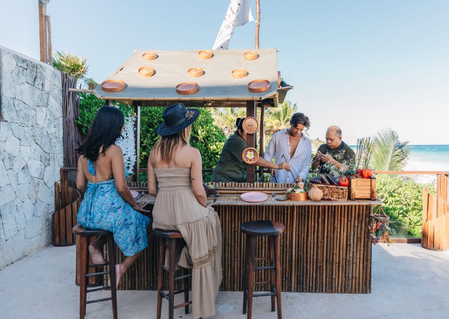 Friends joining a Thai cooking class overlooking the Caribbean at Mezzanine in Tulum